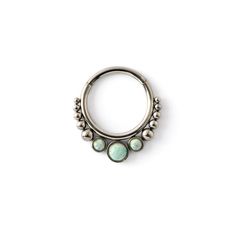 a silver nose ring with turquoise stones on it