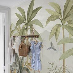 the wallpaper in this room is painted with palm trees, birds and other tropical plants