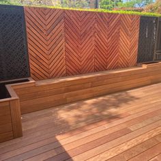 a wooden bench sitting on top of a wooden deck