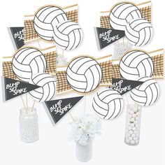 volleyball decorations are arranged in vases and on sticks