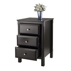 three drawers with flowers in the vase on top of each drawer, and one is black