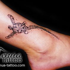 a woman's foot with a tattoo design on it