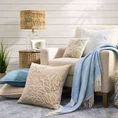 a living room filled with furniture and pillows on top of a blue carpeted floor