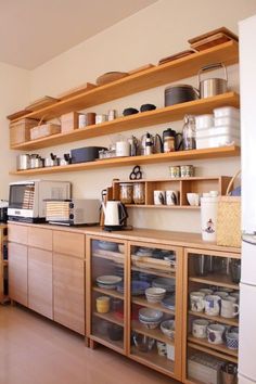 a kitchen filled with lots of wooden shelves