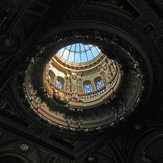 the inside of a building with a skylight in it's center and round windows