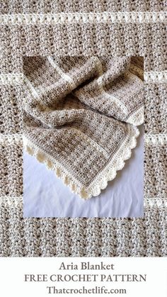 a crocheted blanket is laying on top of a white and brown checkered table cloth