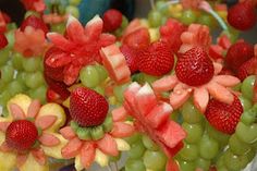 grapes, watermelon and strawberries are arranged in the shape of flowers