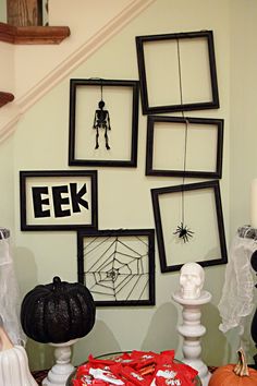 halloween decorations are displayed on the stairs in this home's entryway, decorated with pumpkins and spider webs