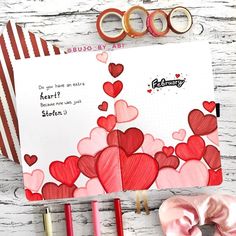 a valentine's day card with scissors, tape and other crafting supplies next to it