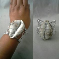 This listing is for one wire wrapped cowrie shell cuff bracelet. This is a beautiful statement piece. Large cowrie shell is wrapped with your choice of silver, gold or copper colored tarnish resist aluminum wire. I want my customers to be happy, so please look carefully at the photos, and feel free to ask any questions. I post new items as soon as they are created so please come back and visit to check for new designs and more bargains and deals: For more styles visit my Etsy shop: www.etsy.com/ Wire Wrapped Cowrie Shell Ring, Bohemian Cowrie Shell Bracelet, Ocean-inspired Shell Jewelry With Wire Wrapped Detail, Bracelet Seashell, Adjustable Wire Wrapped Shell-shaped Jewelry, Ocean-inspired Cowrie Shell For Beach, Wire Cuff Bracelet, Seashell Bracelet, Wire Cuff