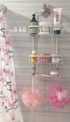 the shower is decorated with pink flowers and accessories