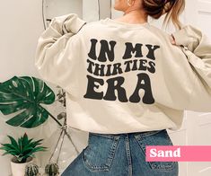 "This sweatshirt is the perfect birthday gift for anyone turning 30! The sweater features the phrase \"In My Thirties Era\" in a bold and eye-catching font. **DETAILS** This Gildan 18000 unisex sweatshirt is cozy and soft, the comfiest sweatshirt you will own! It's comfortable and flattering for both men and women.  - Unisex sizing, please refer to sizing chart in listing photos - 50% cotton, 50% polyester - Medium fabric weight **PRINTING** - DTG (Direct To Garment) Printed  **CARE** - Machine wash: warm (max 40C or 105F) - Do not iron directly on print - Do not tumble dry **SHIPPING** - Products are shipped after 2-7 days in production   **POLICIES** All items are made when you place your order. For this reason we are unable to accept returns / exchanges unless there's a defect in the it Doctor Gift, Mom Sweater, Mom Era, Mama Shirts, Dog Lover Shirt, Comfy Sweatshirt, Sweater Gift, Funny Sweatshirts, Limassol