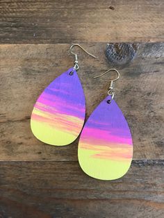 two pairs of wooden earrings with purple and yellow painted tears