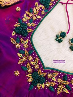 an embroidered purple and green blouse with matching earrings on the neck, along with other accessories