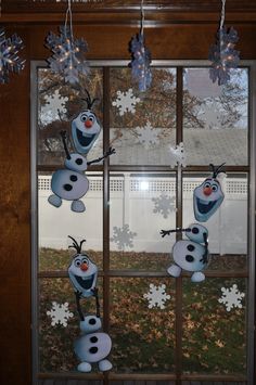 the frozen snowmen are hanging from the window