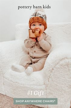 a baby sitting in a chair drinking from a cup with the caption pottery barn kids 1 gift shop anywhere chairs