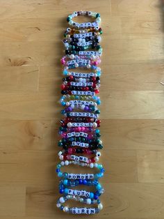 several bracelets are arranged in the shape of an eiffel tower on a wooden floor