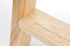 a close up of a wooden bench on a white background with no people around it