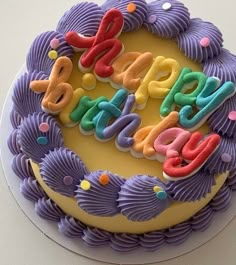 a birthday cake with the word happy spelled out in icing on it's top