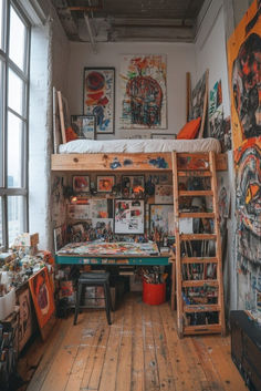 a loft bed sitting in the middle of a room with lots of paintings on the walls