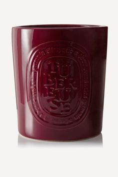 a red glass cup with an emblem on it