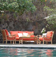 an outdoor seating area next to a swimming pool