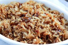 a white bowl filled with rice and meat