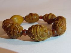 "This bracelet is made with hand carved seed beads representing taoist figures and animals. On the back of one seed it is write probably the artist signature. Period: half 20th century. Back to \"Bracelets\" section: https: https://www.etsy.com/shop/ArteOrientaleBologna?ref=hdr_shop_menu&section_id=18796442 Back to my shop: https://www.etsy.com/shop/ArteOrientaleBologna?ref=hdr_shop_menu" Adjustable Carved Bracelets With Round Beads, Traditional Carved Beaded Bracelets As Gift, Traditional Carved Beaded Bracelets For Gift, Traditional Adjustable Carved Bracelets, Spiritual Carved Round Bracelets, Traditional Carved Adjustable Bracelets, Spiritual Carved Round Beads Bracelets, Spiritual Adjustable Carved Bracelets, Spiritual Carved Adjustable Bracelets