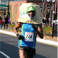 a man wearing a cardboard box on his head while running in a half - marathon