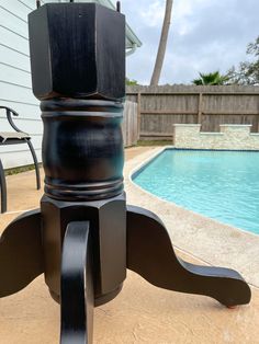 an outdoor table next to a swimming pool