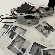 a camera and some pictures on a table