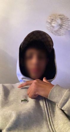 a person wearing a hoodie making a face