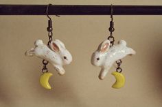 Handmade and painted one of a kind rabbit earrings jumping over small crescent moons Whimsical Moon-shaped Handmade Earrings, Handmade Whimsical Moon Earrings, White Handmade Moon-shaped Earrings, Jumping Rabbit, Rabbit Jumping, Moon Rabbit, Rabbit Earrings, Star Clothing, Clay Projects