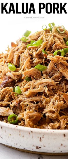 shredded pork with green onions in a white bowl