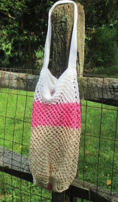 a bag is hanging on a fence post