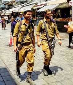 two men in uniform walking down the street