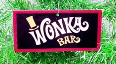 a sign that says wonka bar hanging from a tree