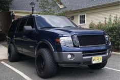 a large blue truck parked in a parking lot