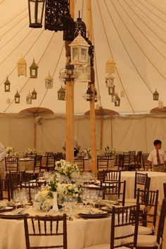 the inside of a tent with tables and chairs