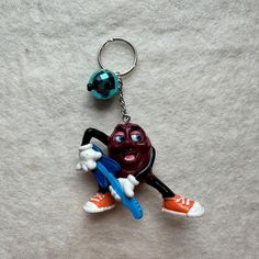 a keychain with a cartoon character holding a toothbrush