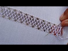 someone is stitching the edge of a piece of fabric