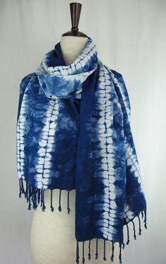 a blue and white tie - dyed scarf on a mannequin