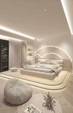 a large white bed sitting in the middle of a bedroom