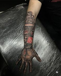 a person with a tattoo on their arm and hand