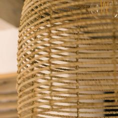 a close up view of the inside of a wicker basket with strings hanging from it