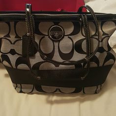 Coach bag Black w/ gray coach bag...has one small stain bearly noticable...gently used but still looks brand new..comes with dust bag & gift box...Great for Mothers Day!! Coach Bags Shoulder Bags Black Coach Bag With Zipper Pouch, Coach Black Coated Canvas Shoulder Bag, Coach Black Shoulder Bag For On-the-go, Coach Shoulder Bag With Removable Pouch For On-the-go, Black Coach Bag With Silver-tone Hardware, Coach Bags, Diaper Bag, Dust Bag, Black And Grey