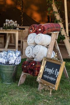 towels stacked on top of each other in front of a sign that says suggle up