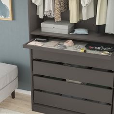 an organized closet with clothes and shoes