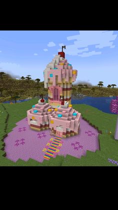 a large pink castle sitting on top of a lush green field