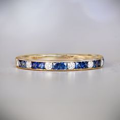 A beautiful wedding band, featuring gorgeous sapphires and diamonds alternately channel-set. With a combined weight of approx 0.34 carats, the sapphires are elongated French cuts. This handcrafted 18k yellow gold band has a combined weight of approx 0.16 carats of round brilliant cut diamonds. ✦ WEDDING BAND SPECIFICATIONS: Total Sapphire Weight: Approx 0.34 Carats Total Diamond Weight: Approx 0.16 Carats Stone: Diamond and Sapphire Material: 18K Yellow Gold ✦ WHAT COMES IN YOUR SHIPMENT: - Your Sapphire And Diamond Band, Estate Diamond Jewelry, Beautiful Wedding Bands, French Cut, Sapphire Band, Jewelry Cleaner, Sapphire Diamond, Round Brilliant Cut Diamond, Diamond Bands